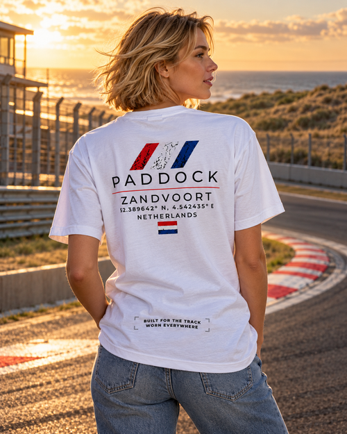 Woman wearing a GRYD1 Paddock Zandvoort T-shirt in an atmospheric motorsport setting | Shared