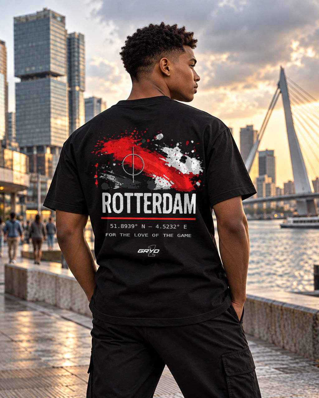 Young man wearing a GRYD1 Stadium Rotterdam T-shirt near the Erasmus Bridge | Shared