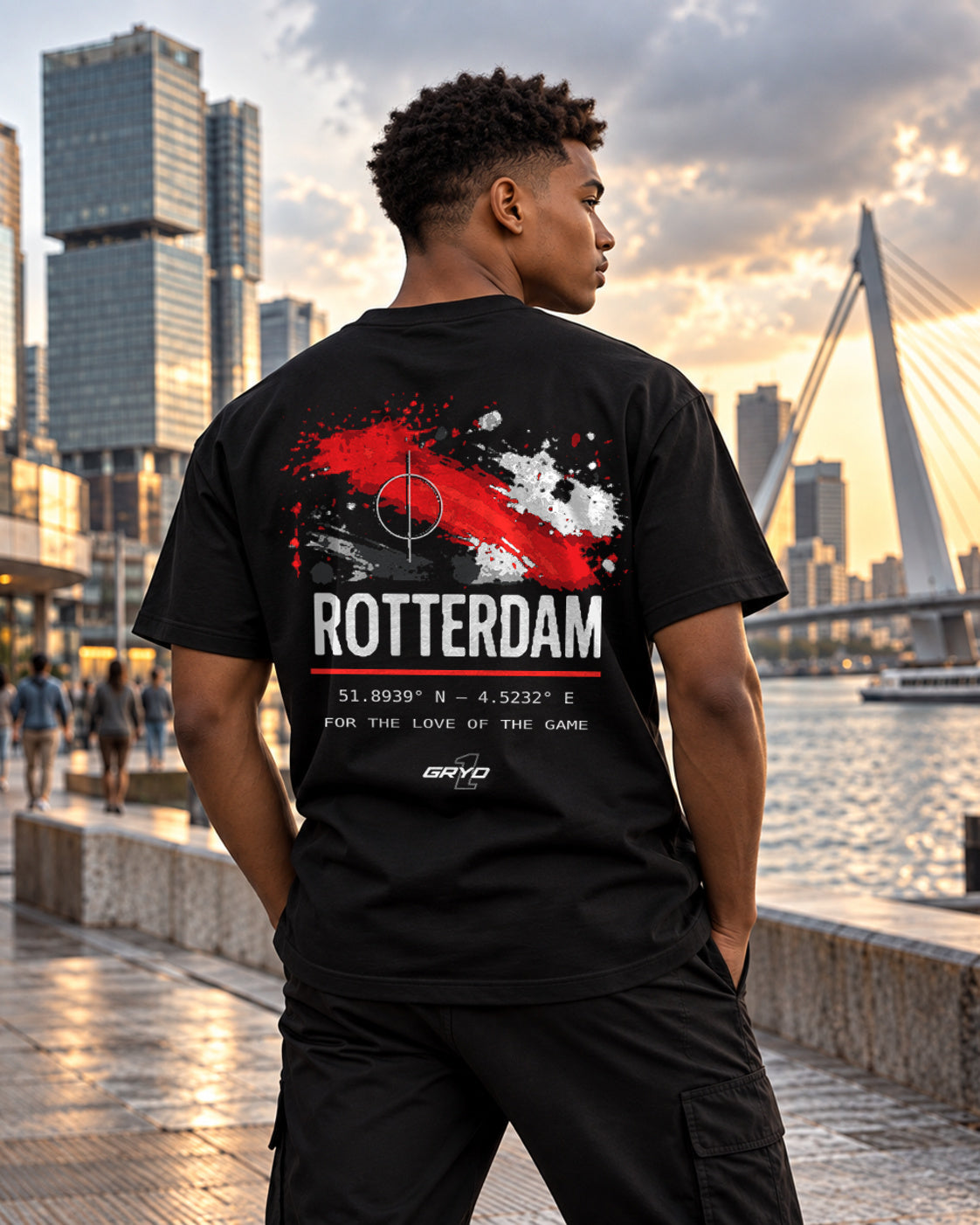 Young man wearing a GRYD1 Stadium Rotterdam T-shirt near the Erasmus Bridge | Shared